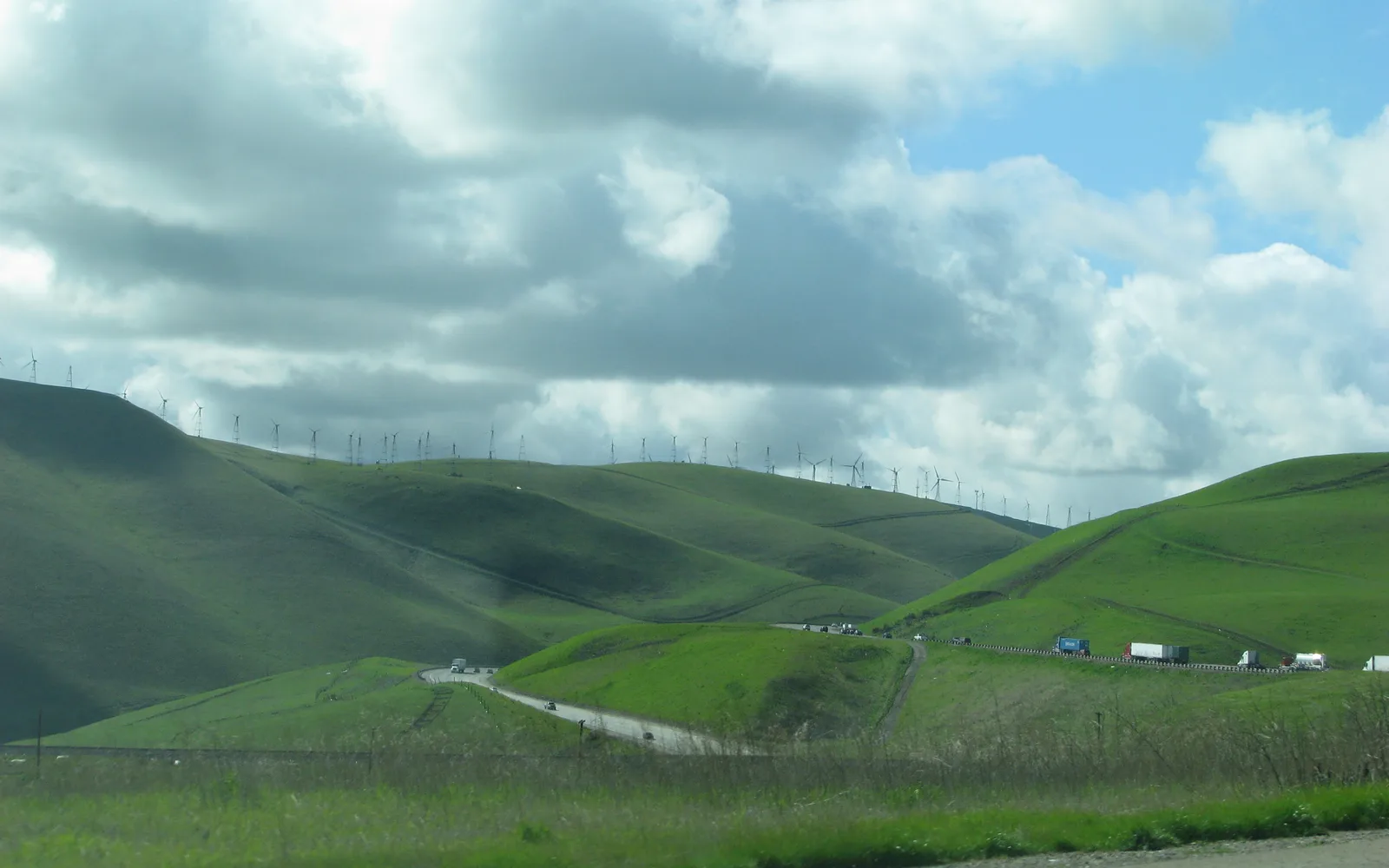 Interstate 580 westbound between Pleasanton and Castro Valley in the Altamont Pass corridor, showing the multi-lane highway with rolling hills and California landscape